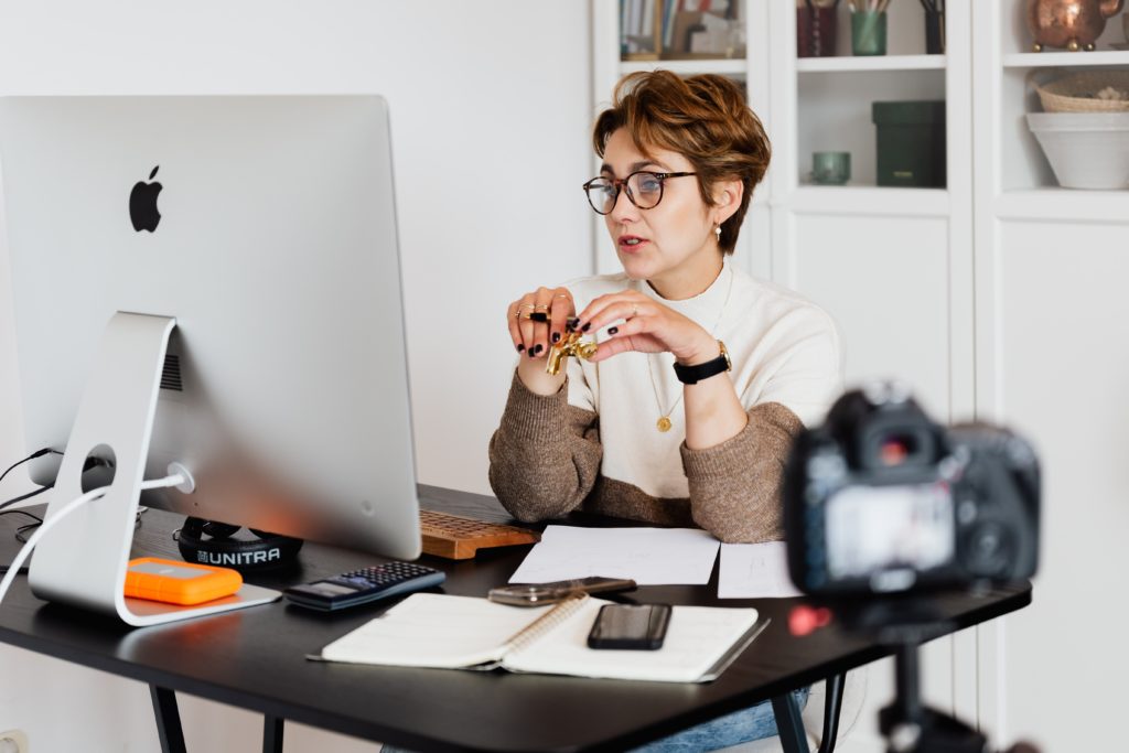 image of a woman in her office working from home, looking at her computer screen
